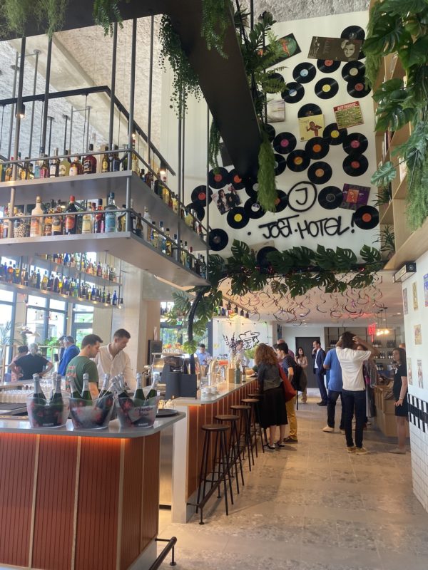 Vue d'un bar à gauche et en haut a droite sur le mur est écrit Jost Hôtel
